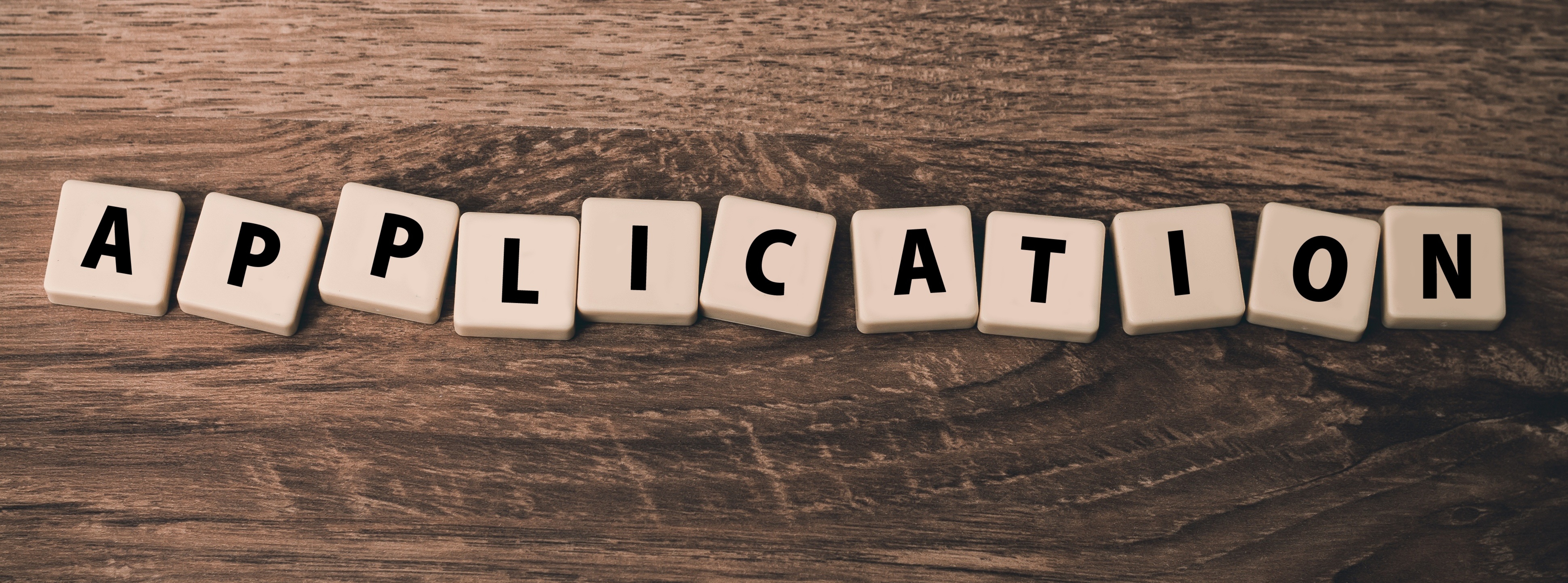 Letter tiles that spell "application"