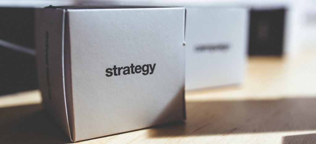 white paper box with the word "strategy" printed on it