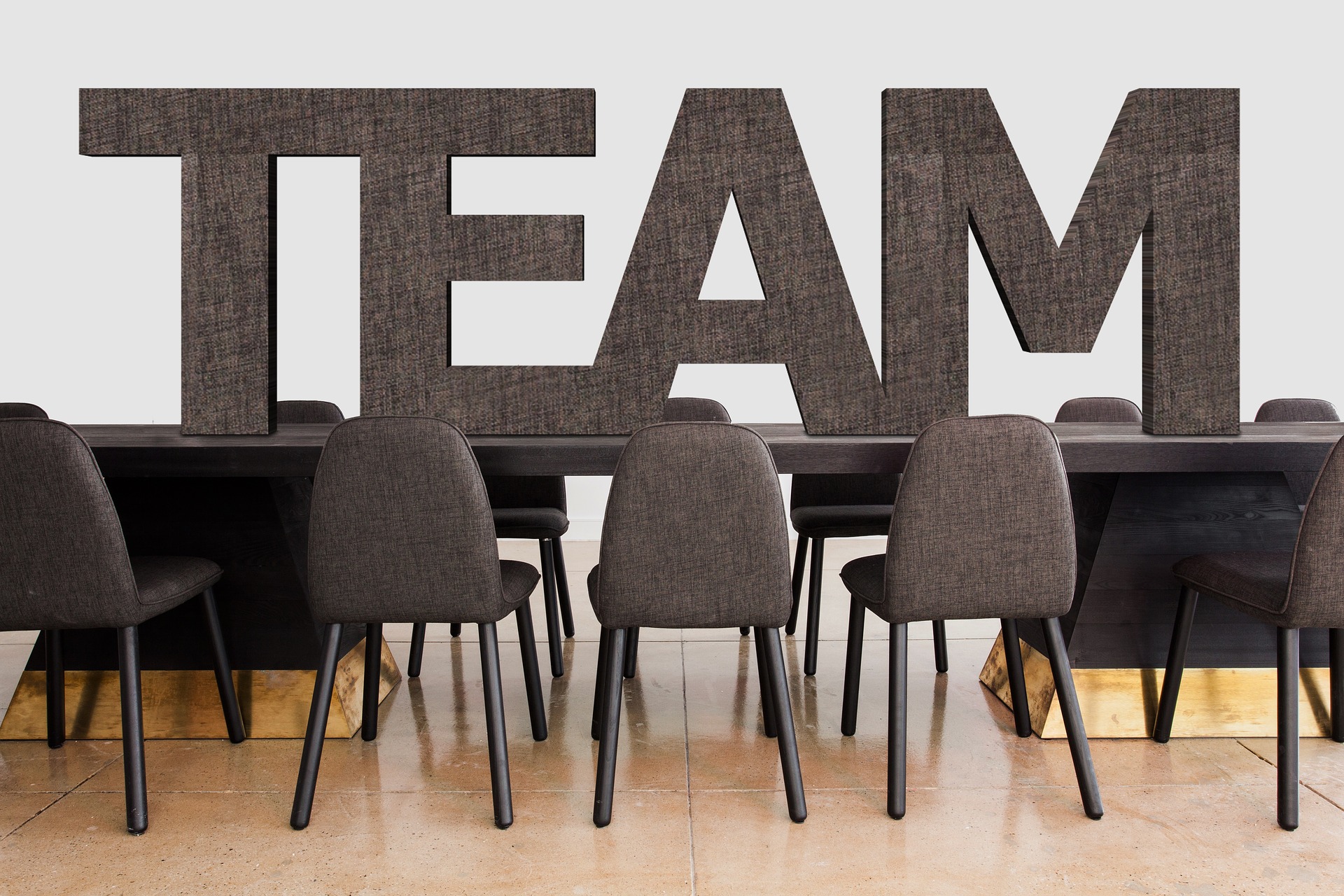 The word "Team" placed above a conference table